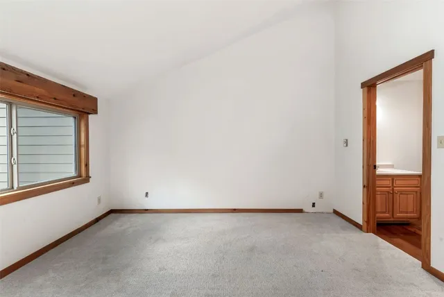 a view of staircase with railing and white walls