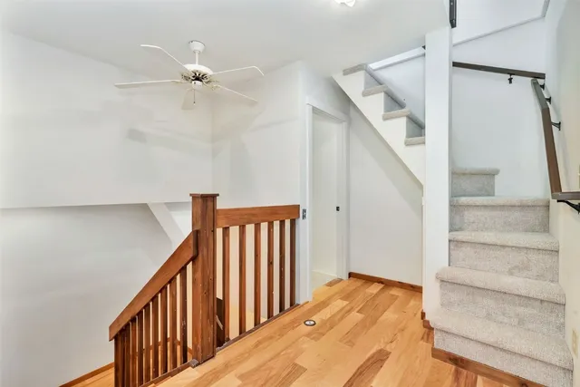 a bathroom with a granite countertop shower and a toilet