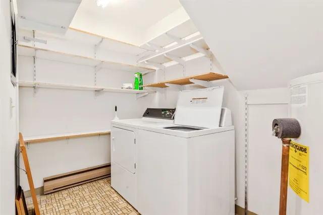 a view of staircase with lots of frames and frames on wall with wooden floor