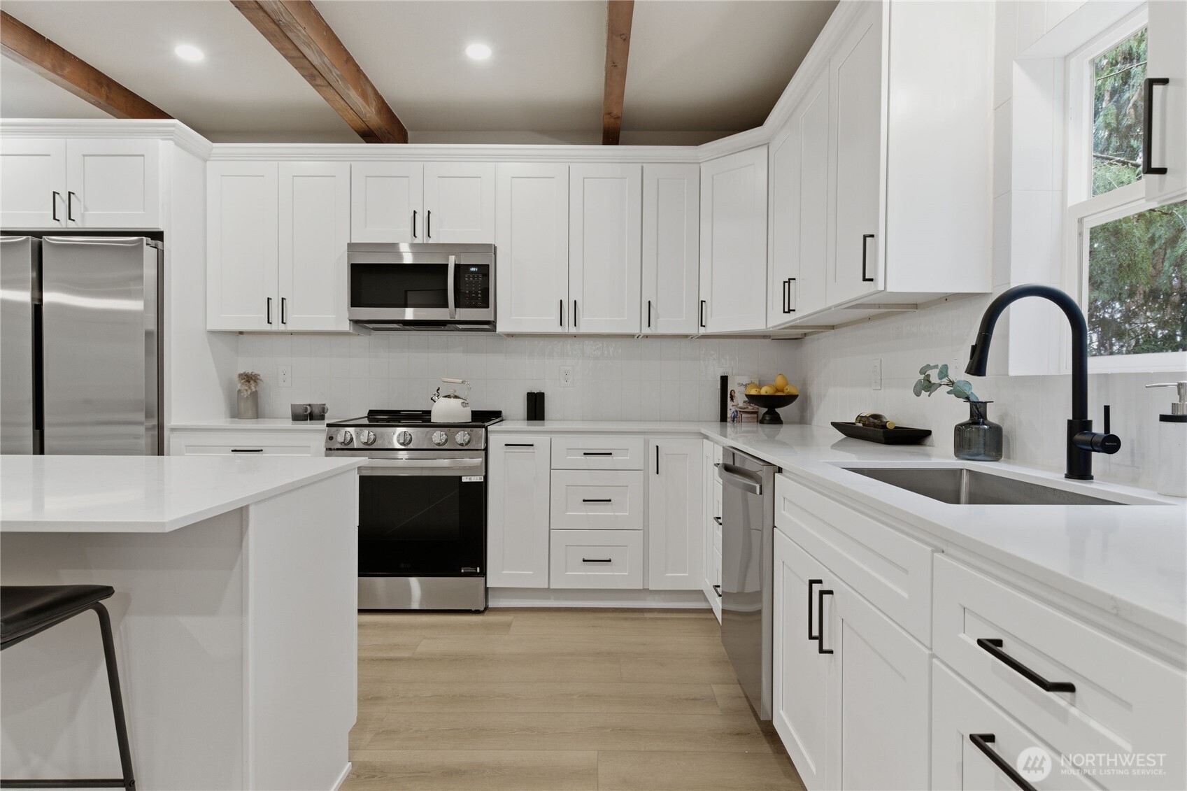 25816 178th Street Southeast Monroe, WA 98272 - Photo 11 of 40 a kitchen with white cabinets and stainless steel appliances