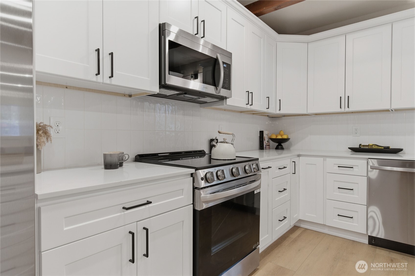25816 178th Street Southeast Monroe, WA 98272 - Photo 12 of 40 a kitchen with stainless steel appliances granite countertop white cabinets a sink a stove and dishwasher