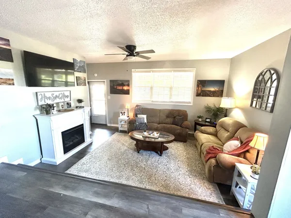 a living room with furniture fireplace and a flat screen tv
