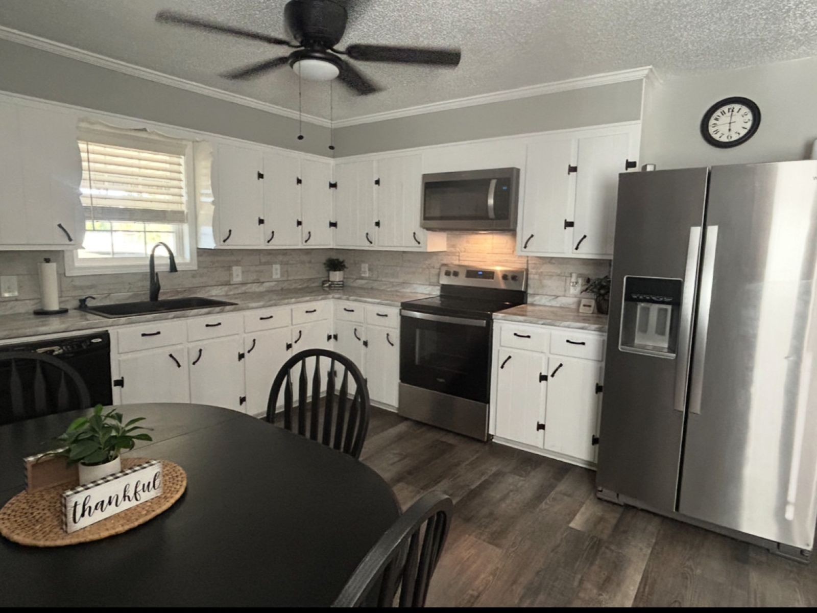 1800 Ozment Road Dyersburg, TN 38024 - Photo 14 of 30 a kitchen with a refrigerator stove microwave and cabinets