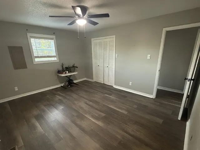 a bedroom with a bed a couch and a window