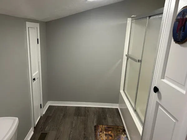 a view of room with wooden floor and a sink