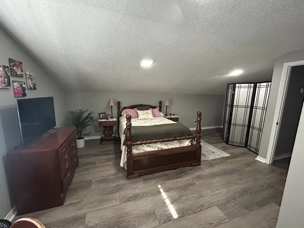 a bedroom with furniture and a flat screen tv