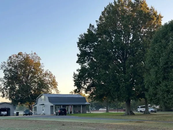 a front view of a building with trees