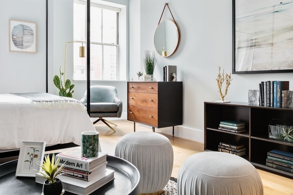 63 Wall Street, Unit 405 Manhattan, NY 10005 - Photo 2 of 20 a bedroom with furniture and a mirror