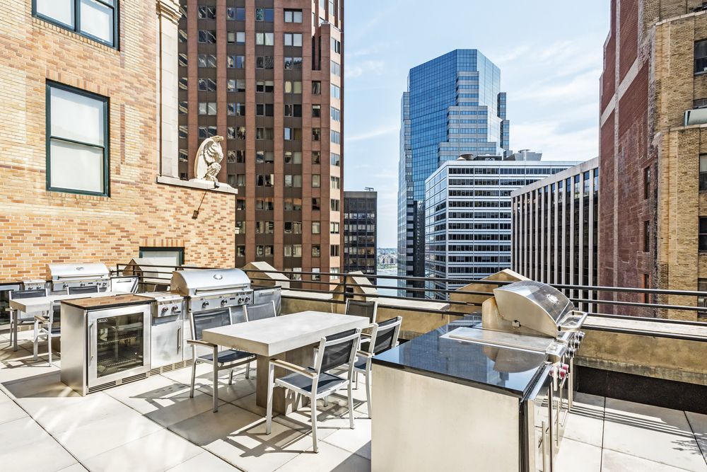 63 Wall Street, Unit 405 Manhattan, NY 10005 - Photo 8 of 20 a table and chairs sitting in front of a building