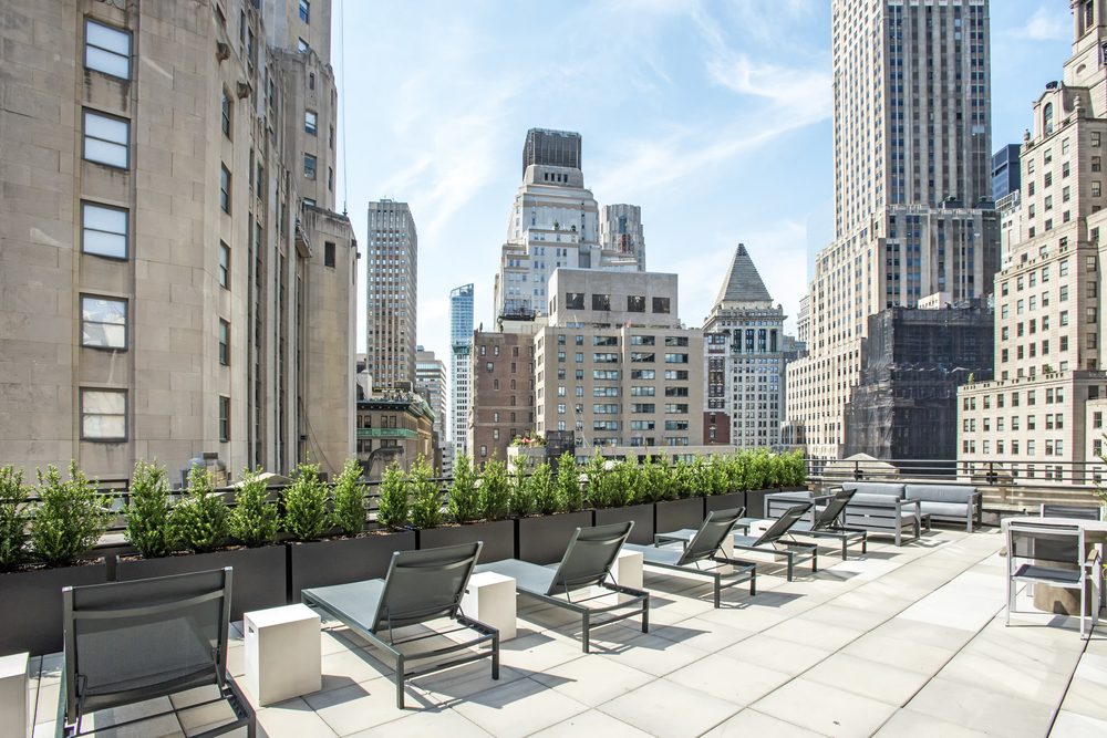 63 Wall Street, Unit 405 Manhattan, NY 10005 - Photo 9 of 20 a view of a patio with plants and chairs