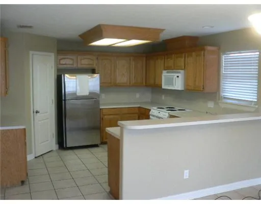 a kitchen with a sink appliances and cabinets