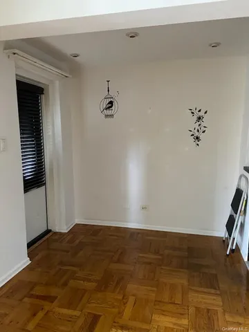 a view of a room with wooden floor and shoes