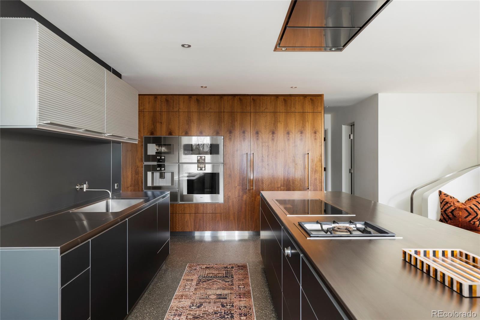 801 South Ellipse Way Denver, CO 80209 - Photo 17 of 50 a kitchen with kitchen island granite countertop a sink stove and refrigerator