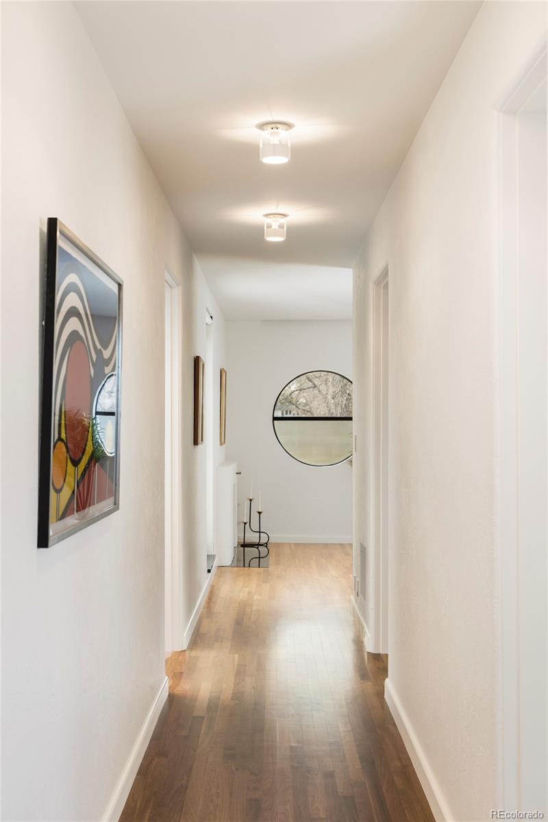 801 South Ellipse Way Denver, CO 80209 - Photo 21 of 50 a view of a hallway with wooden floor