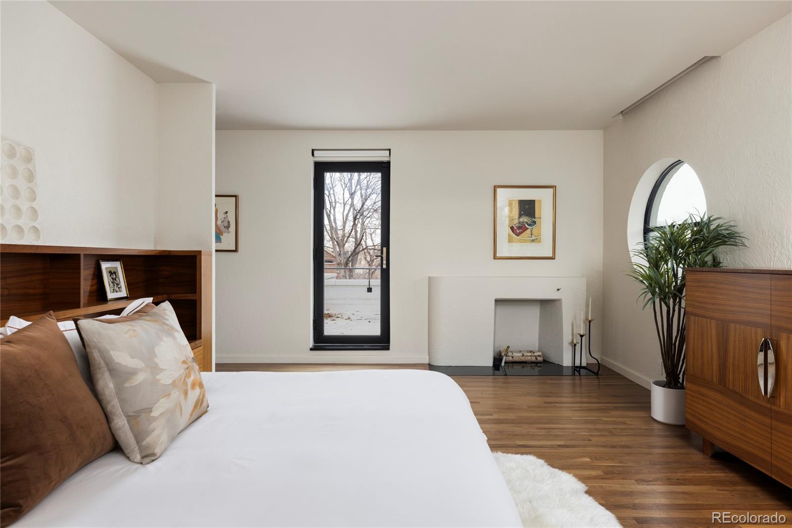 801 South Ellipse Way Denver, CO 80209 - Photo 24 of 50 a bedroom with a bed and a potted plant