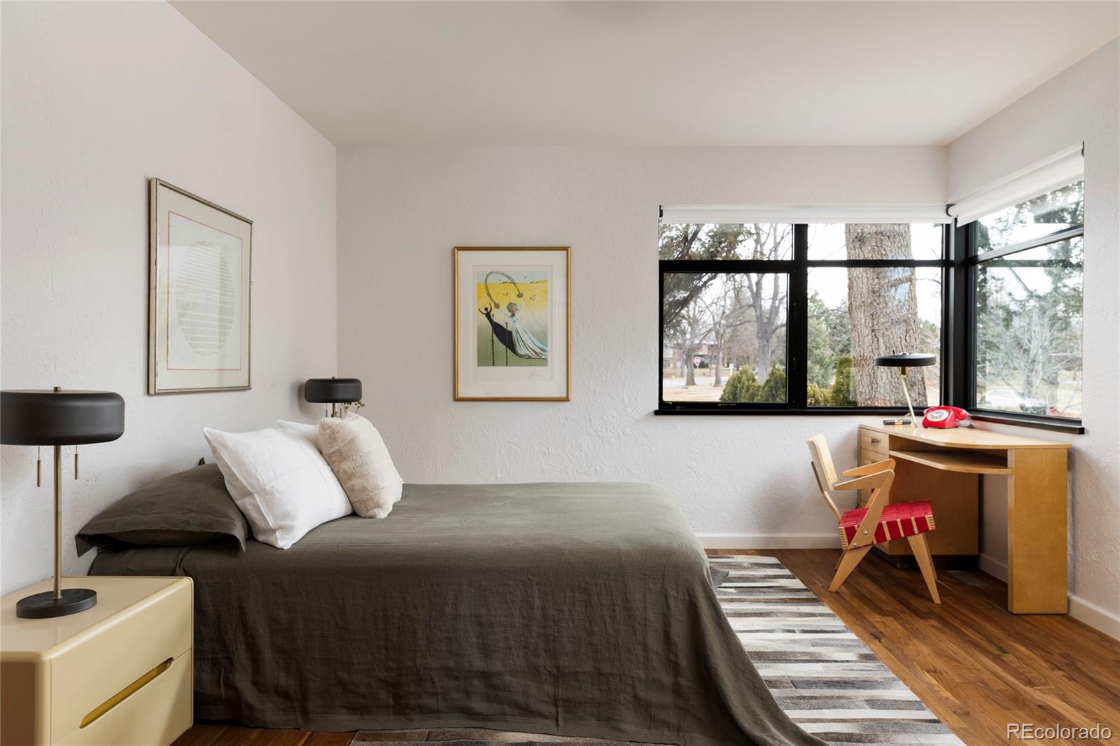 801 South Ellipse Way Denver, CO 80209 - Photo 31 of 50 a bedroom with a bed and wooden floor