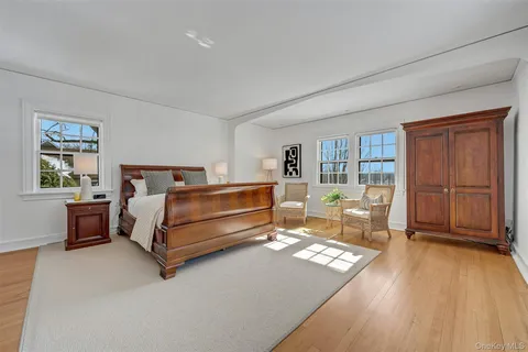 a bedroom with a bed and dresser with mirror