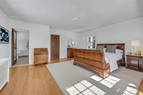 a bedroom with a large bed and a window