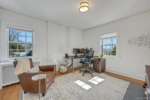 a view of a room with wooden floor and a bathroom