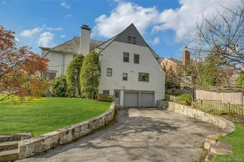 a front view of a multi story residential apartment building with a yard