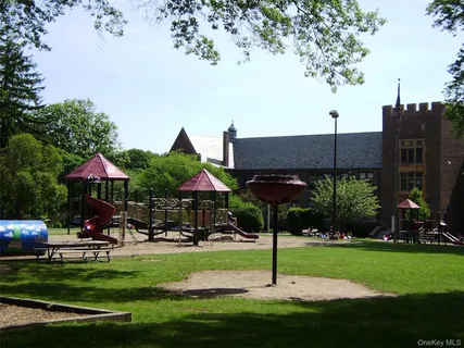 a view of a big yard with lots of green space and mountain view