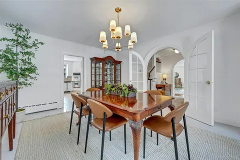 a dining room with furniture and chandelier