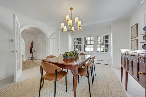 a view of a dining room with furniture and chandelier