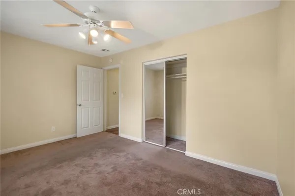 a view of an empty room with a fan