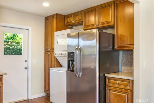 a bathroom with a refrigerator and washer