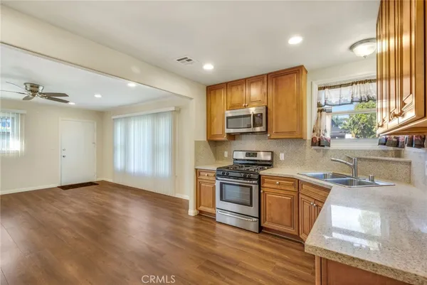 a kitchen with granite countertop a stove top oven and sink