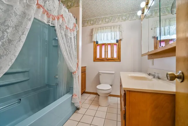 a bedroom with a bed a lamp and a dresser