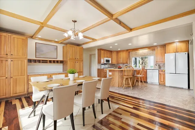 a view of a kitchen with kitchen island dining table and wooden floor