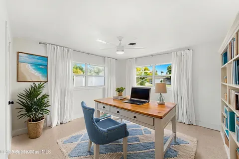 a workspace with furniture and a potted plant