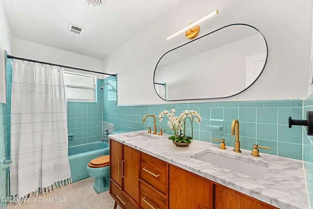 a bathroom with a sink mirror vanity and toilet
