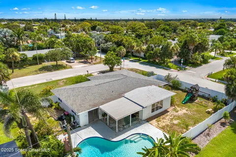 an aerial view of a house with swimming pool and outdoor space