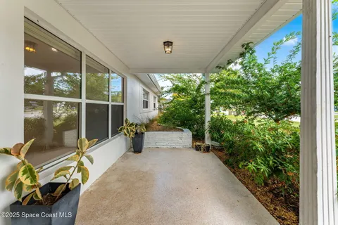 a view of a patio with table and chairs and potted plants