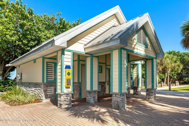 an aerial view of a house with a swimming pool an outdoor seating and ocean view