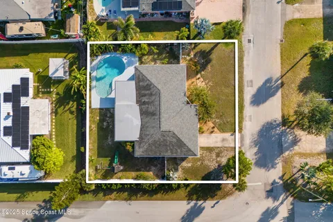 an aerial view of a house with swimming pool