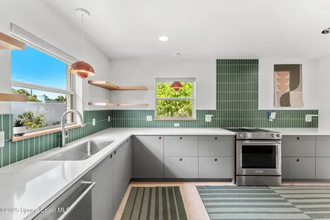a kitchen with a sink and a stove