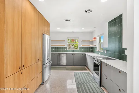 a kitchen with white cabinets and white appliances