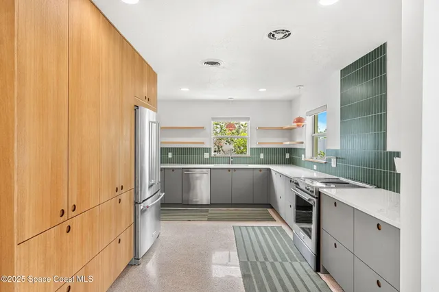 a kitchen with white cabinets and white appliances