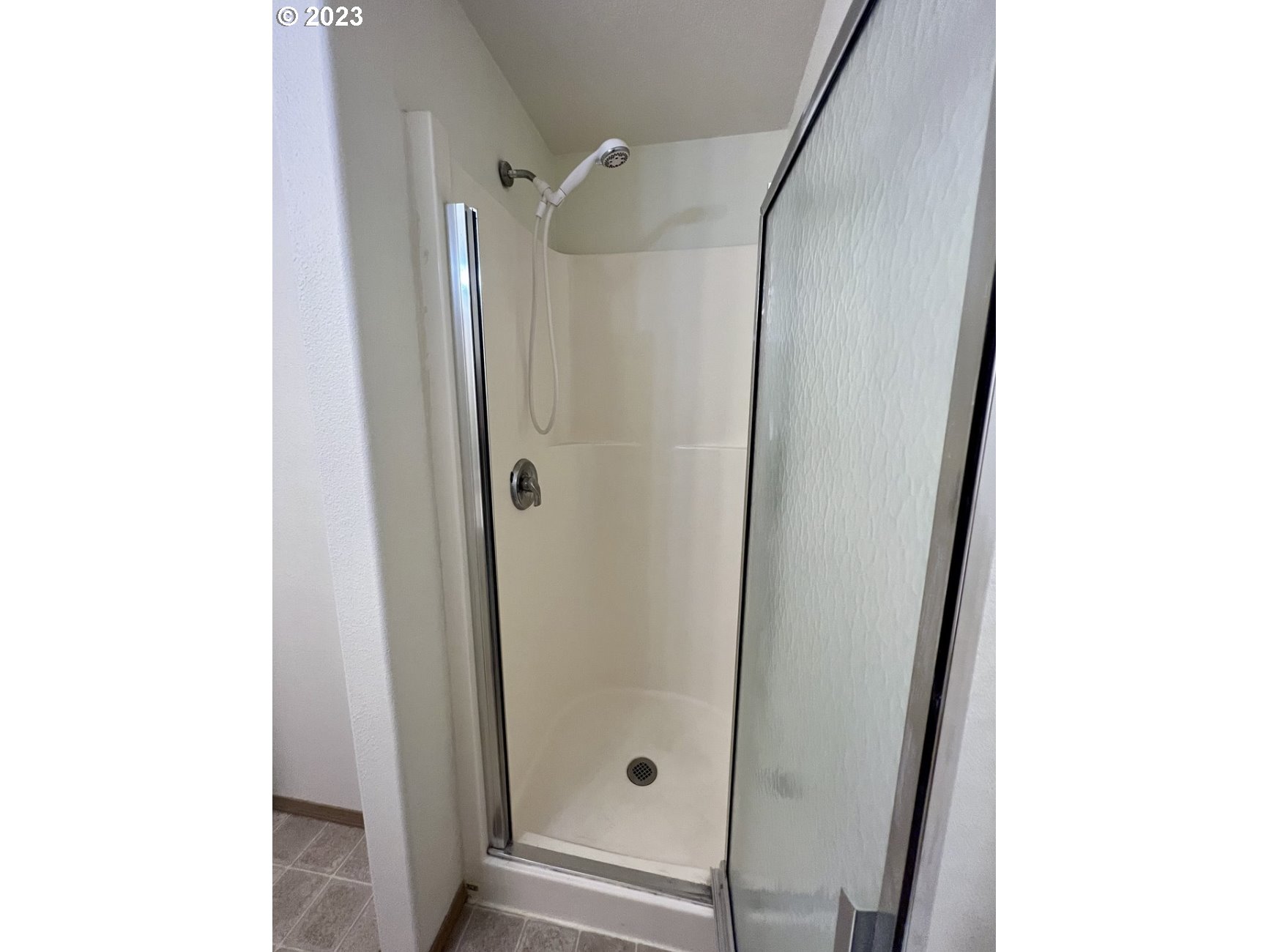 1001 Southwest Nye Avenue Pendleton, OR 97801 - Photo 12 of 14 a bathroom with a glass shower door and a mirror