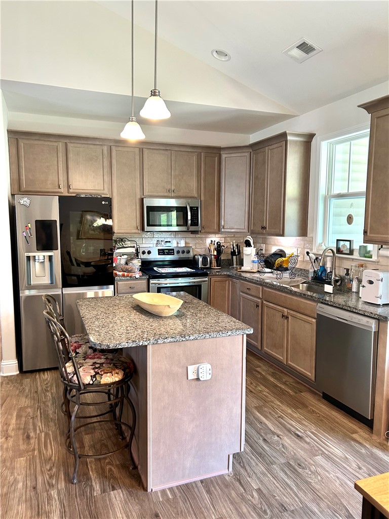 170 Capslock Trail Pendleton, SC 29670 - Photo 3 of 22 Vaulted ceilings soar over a central kitchen island and polished granite countertops.