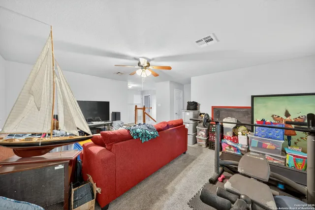 a bedroom with a bed a couch and dresser