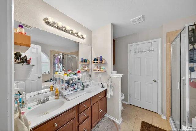 a bedroom with a bed and a mirror