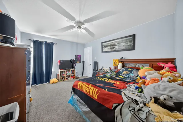 a bedroom with a bed a flat screen tv and dresser