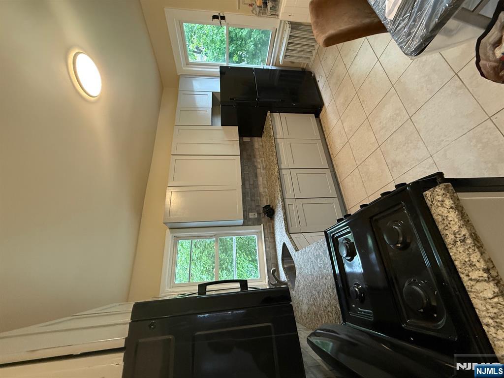 a kitchen with a stove a refrigerator and cabinets