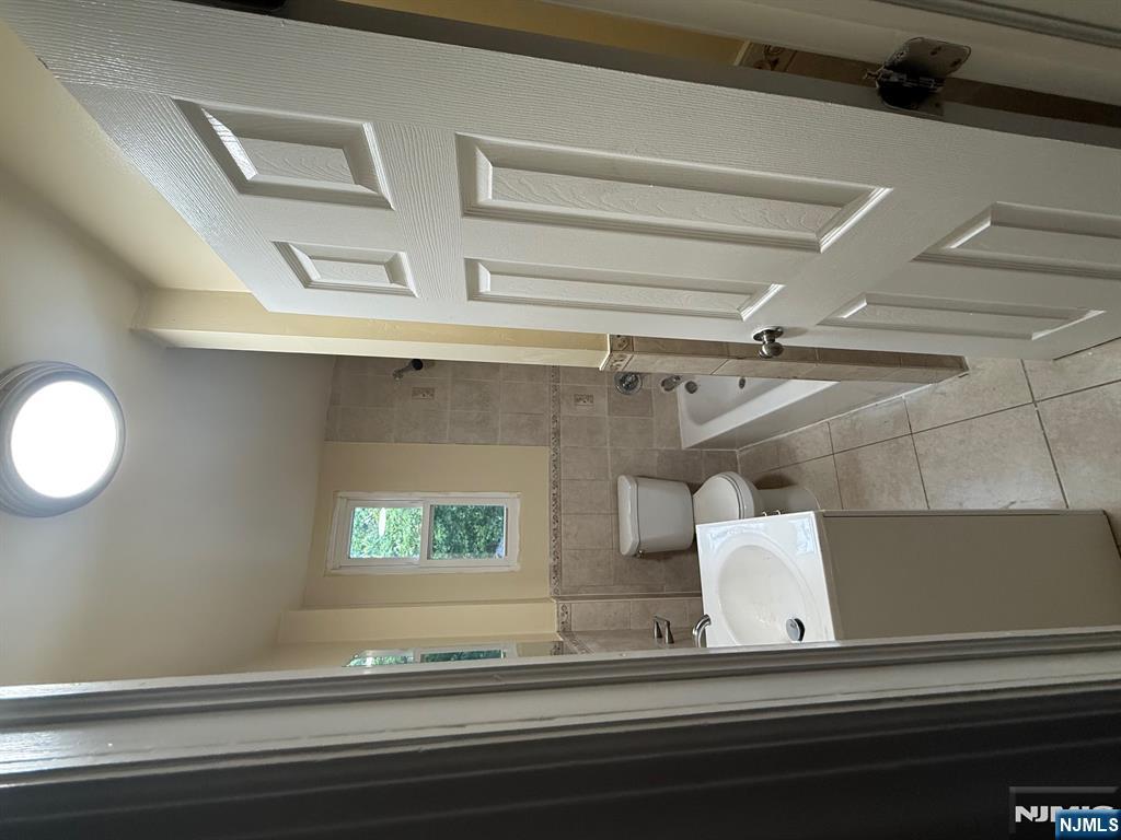 149-151 Scheerer Avenue, Unit 2 Newark, NJ 07112 - Photo 4 of 11 a bathroom with a sink a toilet and shower