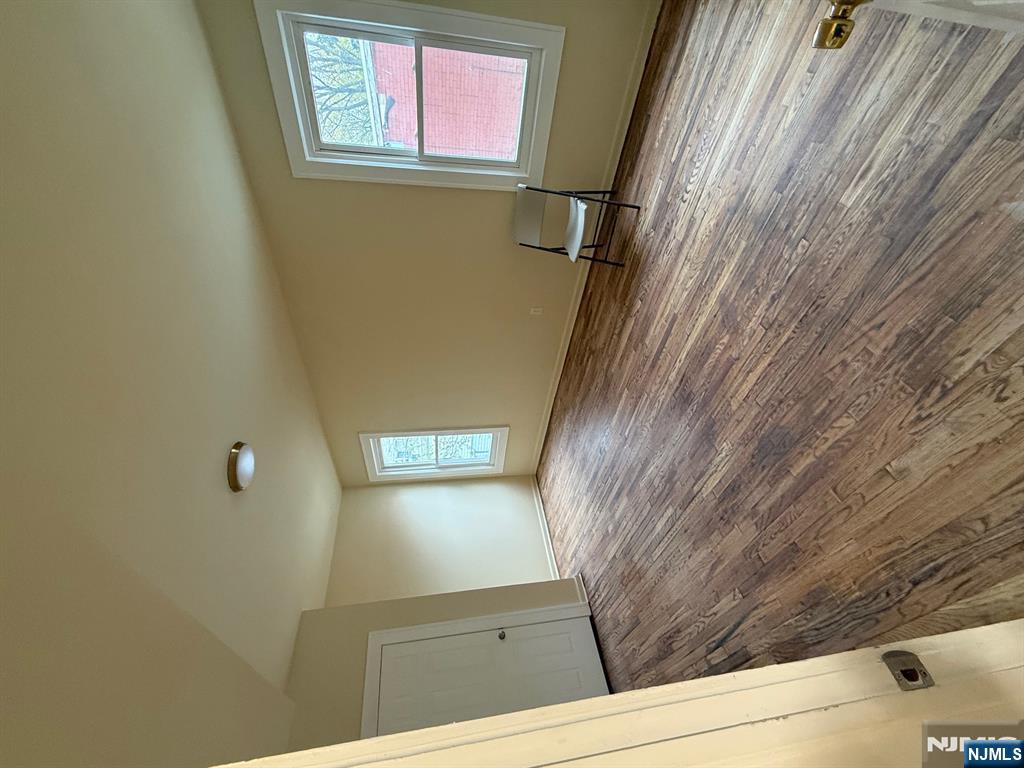 149-151 Scheerer Avenue, Unit 2 Newark, NJ 07112 - Photo 8 of 11 an empty room with wooden floor and windows