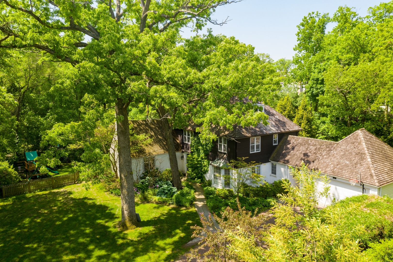 710 Walden Road Winnetka, IL 60093 - Photo 1 of 28 a backyard of a house with a yard and plants
